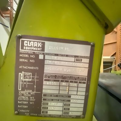 Sale Photo Thumbnail #3: Manufacturer data plate on a lime green Clark electric industrial forklift model TW 25.