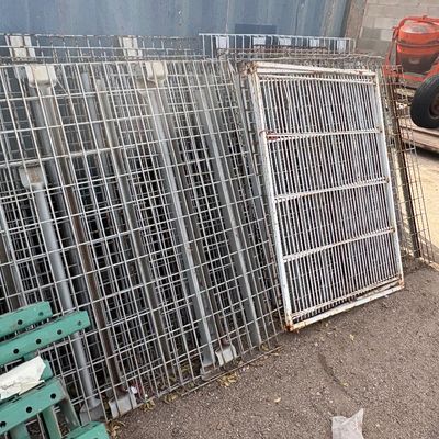 Sale Photo Thumbnail #44: Large stack of heavy-duty metal wire pallet racking decking and industrial shelving panels showing surface rust and wear.