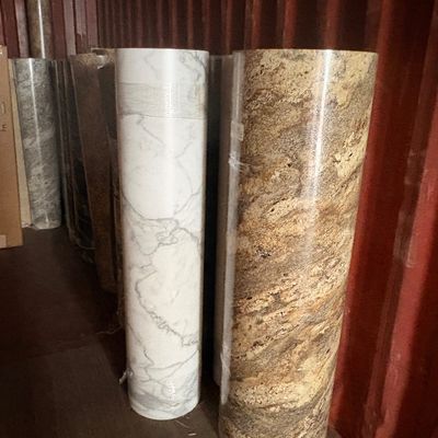 Sale Photo Thumbnail #53: Rolls of faux marble and stone pattern vinyl flooring, stored vertically inside a shipping container.