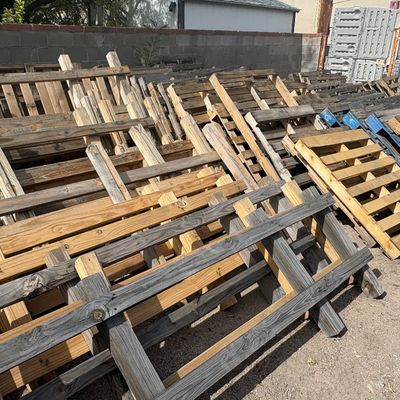 Sale Photo Thumbnail #42: Large stack of weathered wooden shipping pallets stored outdoors against a wall.