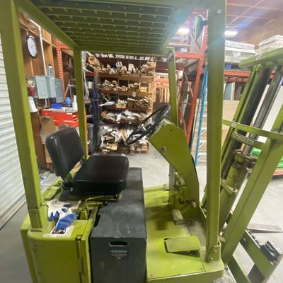 Sale Photo Thumbnail #5: Vintage chartreuse Clark electric industrial forklift with overhead guard cage, showing moderate surface wear and paint loss.