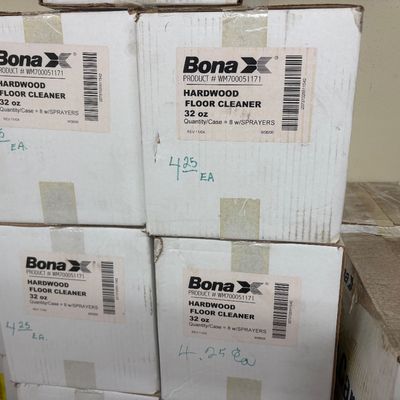 Sale Photo Thumbnail #30: Stacked cases of Bona Hardwood Floor Cleaner, 32 oz size with sprayers, marked at $4.25 each.