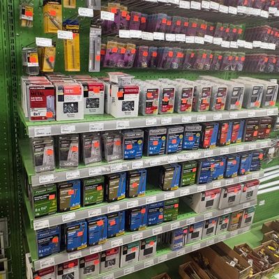 Sale Photo Thumbnail #69: Retail shelving stocked with various boxed fasteners, drill bits, and screws, including brands like Power Pro and Hillman.