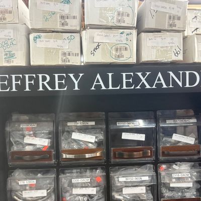 Sale Photo Thumbnail #21: Jeffrey Alexander retail hardware display rack filled with various styles of cabinet pulls and knobs, along with boxed stock stored on top.