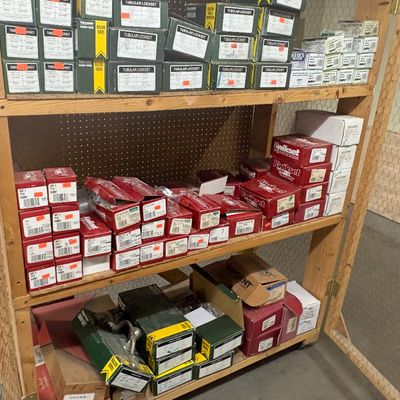 Sale Photo Thumbnail #78: Wooden shelving unit stocked with boxed door hardware, including Kwikset and Taymor locksets, knobs, and handles.