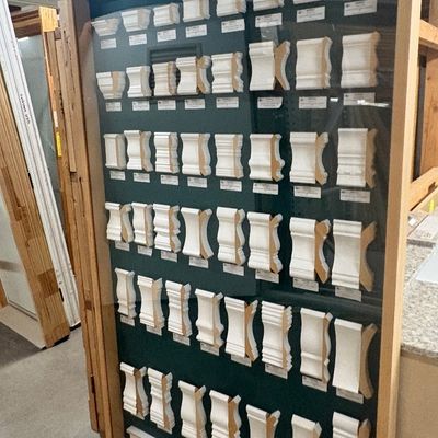 Sale Photo Thumbnail #81: Large wooden framed display case containing various crown molding cross-section samples, manufactured by EL & EL Wood Products.