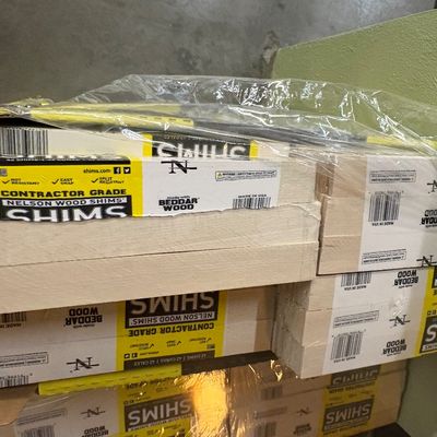 Sale Photo Thumbnail #17: Stack of contractor-grade Nelson Wood Shims packages, sealed in plastic wrap.