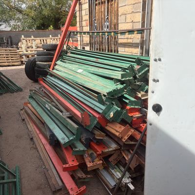 Sale Photo Thumbnail #47: Large stack of heavy-duty industrial metal pallet racking beams and crossbars in green and orange finish.
