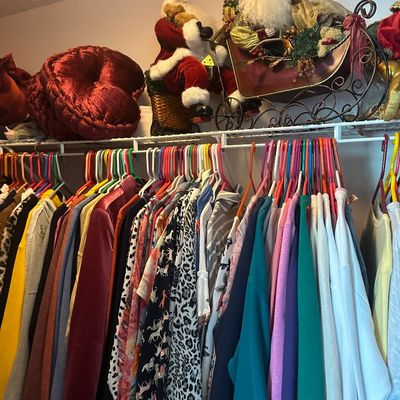 Sale Photo Thumbnail #60: Closet full of women's colorful clothing hanging on plastic hangers, with Christmas decorations and velvet throw pillows displayed on the shelf above.