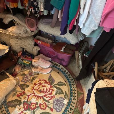 Sale Photo Thumbnail #55: Closet floor filled with women's clothing, footwear, storage bins, and a round floral needlepoint rug.