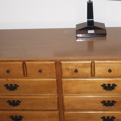 Sale Photo Thumbnail #16: Traditional maple double dresser featuring eight drawers with dark metal hardware and a laminate surface top.