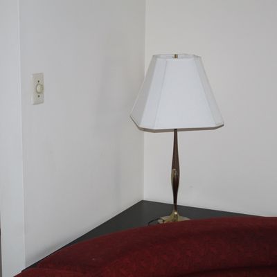Sale Photo Thumbnail #22: Mid-century modern table lamp featuring a slender teak and brass stem, paired with a white hexagonal shade.