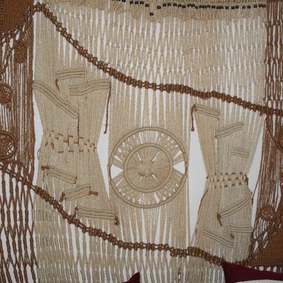 Sale Photo Thumbnail #3: Large vintage 1970s macrame wall hanging featuring intricate woven fiber details in natural cream and brown earth tones.