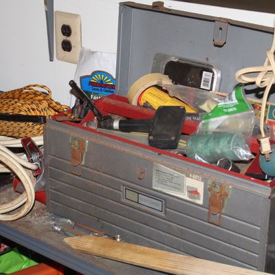 Sale Photo Thumbnail #149: Vintage metal Craftsman toolbox filled with various hand tools and hardware accessories, showing rusted metal clasps and signs of wear.