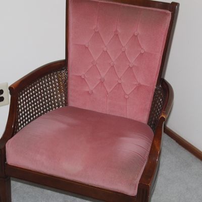 Sale Photo Thumbnail #38: Vintage arm chair featuring dusty rose velvet tufted upholstery and woven cane side panels on a dark wood frame.