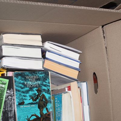 Sale Photo Thumbnail #158: Cardboard box packed with a variety of vintage and modern hardcover and paperback books, including 'Where the Raritan Flows' by Earl Schenck Miers.