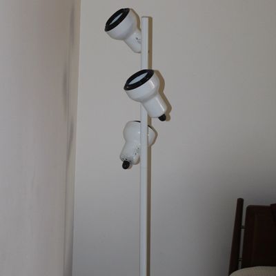 Sale Photo Thumbnail #2: Vintage white metal three-light track-style floor lamp with adjustable black-rimmed spotlights.