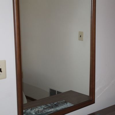 Sale Photo Thumbnail #10: Large rectangular wall mirror in a simple wooden frame, mounted above a matching wooden dresser surface.