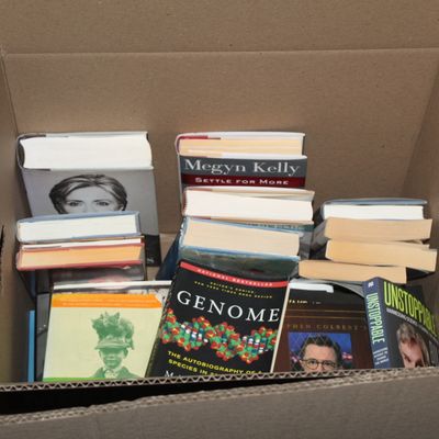 Sale Photo Thumbnail #146: Cardboard box filled with assorted hardcover and paperback non-fiction books, including titles on politics, science, and memoirs.