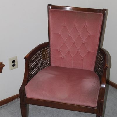 Sale Photo Thumbnail #39: Vintage wood-framed armchair featuring dusty rose velvet tufted upholstery and woven cane side panels.