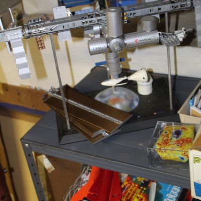 Sale Photo Thumbnail #103: Detailed International Space Station display model featuring NASDA and ESA logos mounted on a stand.
