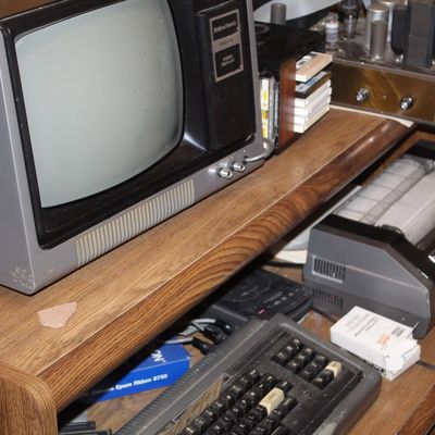 Sale Photo Thumbnail #113: Vintage Radio Shack TRS-80 monochrome video display computer monitor, shown alongside a period dot matrix printer, keyboard, and audio electronics on a wooden desk.