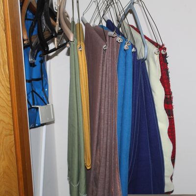 Sale Photo Thumbnail #40: Collection of fabric lengths hanging on specialty hangers inside a closet.