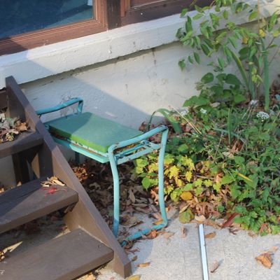 Sale Photo Thumbnail #29: Vintage metal outdoor stool with blue frame and green seat, positioned outdoors under wooden steps.