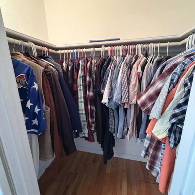 Sale Photo Thumbnail #54: Walk-in closet filled with men's casual clothing, including button-down plaid shirts, jackets, and a Pro Bowl jersey.