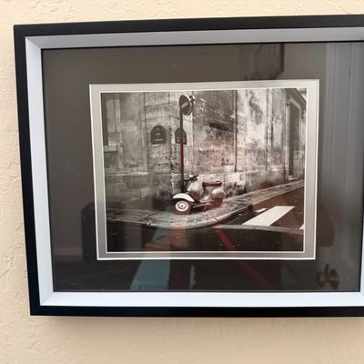 Sale Photo Thumbnail #20: Framed black-and-white art photograph depicting a vintage scooter parked on a Paris street corner, presented in a black frame with a double mat.