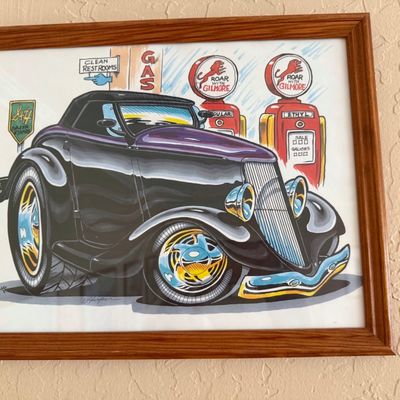 Sale Photo Thumbnail #6: Framed caricature art print featuring a vintage hot rod parked at a Gilmore gas station, presented in a simple wood frame.
