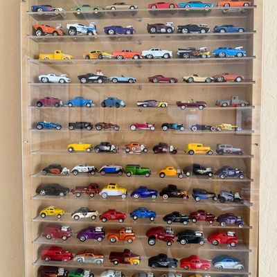 Sale Photo Thumbnail #5: Wall-mounted light wood display case filled with a collection of die-cast toy cars and hot rods.