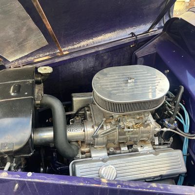 Sale Photo Thumbnail #27: Detailed view of a supercharged engine bay inside a purple custom hot rod or vintage car.