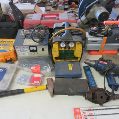 Sale Photo Thumbnail #36: Collection of work equipment including a NAVAC vacuum pump, Appion refrigerant recovery machine, Ryobi heat gun, and assorted hand tools and cases.