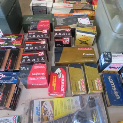 Sale Photo Thumbnail #52: Large assortment of boxed ammunition from brands including Federal, Winchester, PMC Bronze, and Samson, shown alongside plastic dry storage ammo boxes.