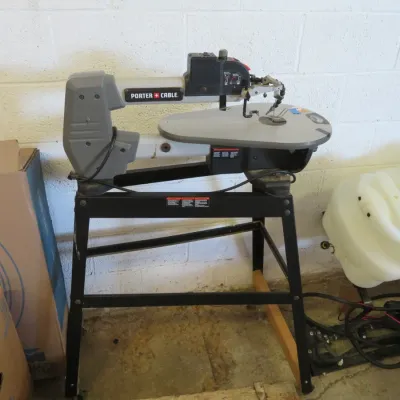 Sale Photo Thumbnail #21: Porter-Cable variable speed scroll saw mounted on a black metal utility stand.