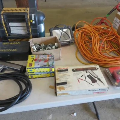 Sale Photo Thumbnail #46: Collection of garage tools and accessories, including a Mr. Heater portable heater, Craftsman timing analyzer, orange extension cord, and work light.