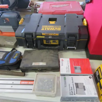 Sale Photo Thumbnail #35: Collection of modern power tools and supplies, including a DeWalt ToughSystem 2.0 toolbox, Milwaukee carrying case, vacuum pump, and electrical disconnect switches.