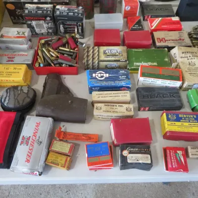 Sale Photo Thumbnail #54: Large assortment of vintage and modern ammunition, reloading supplies, and shooting accessories, including boxed cartridges from Winchester, Hornady, and Herter's.