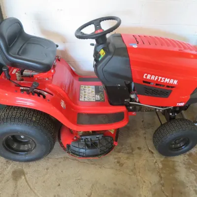 Sale Photo Thumbnail #9: Craftsman T100 riding lawn mower in bright red with a black vinyl seat.