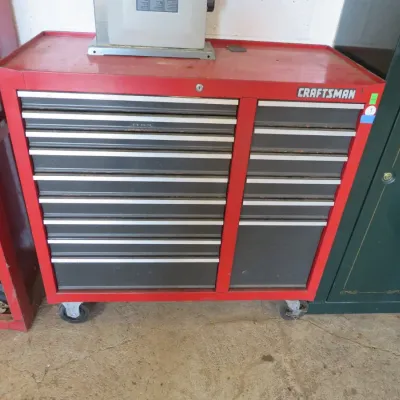 Sale Photo Thumbnail #7: Vintage Craftsman red rolling tool chest with double-column drawers and silver-tone trim handles, set on casters.