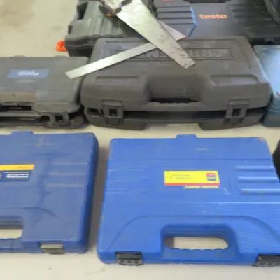 Sale Photo Thumbnail #33: Assorted modern hard plastic tool cases including Yellow Jacket brand, along with hand saws resting on top.