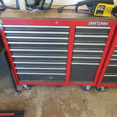 Sale Photo Thumbnail #16: Vintage red and black Craftsman multi-drawer rolling tool chest cabinet, featuring silver-toned drawer handles and heavy-duty casters.