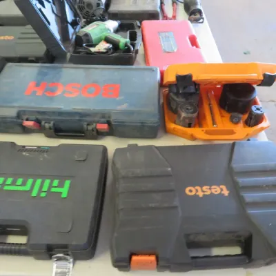 Sale Photo Thumbnail #32: Collection of power tools and specialty equipment in molded plastic carrying cases, including brands such as Hilmor, Testo, and Bosch.