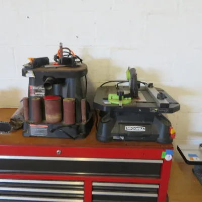 Sale Photo Thumbnail #18: WEN oscillating spindle sander alongside a Rockwell BladeRunner portable tabletop saw, resting on a red tool chest.