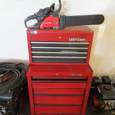 Sale Photo Thumbnail #12: Red Craftsman two-piece rolling tool chest combo topped with a red Craftsman gas-powered chainsaw.