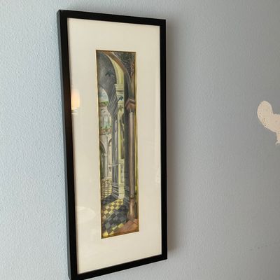 Sale Photo Thumbnail #117: Narrow, vertical architectural watercolor illustration framed in a black wood frame with cream matting, depicting classical European arches and checkered tile floors.