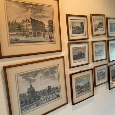 Sale Photo Thumbnail #60: Gallery wall featuring a large collection of framed vintage landscape and architectural engravings and prints in matching wood frames.