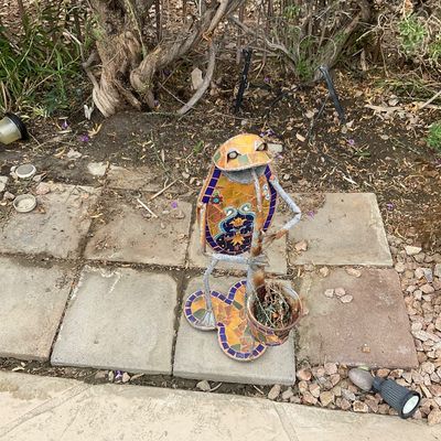 Sale Photo Thumbnail #37: Whimsical metal and mosaic tile frog garden statue holding a small planter pot, featuring weather-worn finishes.