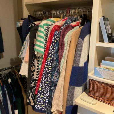 Sale Photo Thumbnail #170: Closet filled with women's clothing on hangers, featuring a variety of patterned tops, sweaters, and cardigans.